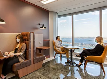 Servcorp clients at 10 Avenue Kléber working and meeting confidently in a premium coworking with panoramic city views.