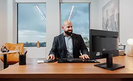 Businessman in a serviced office at 10 Avenue Kléber, enjoying premium workspace, city views, and professional amenities.